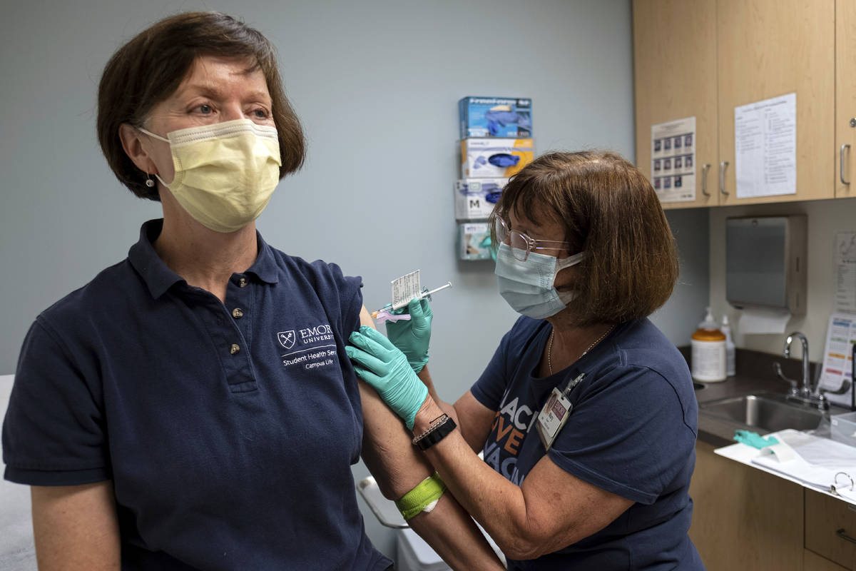 Carol Kelly, left, receives a Moderna variant vaccine shot from registered nurse Mary Bower at ...