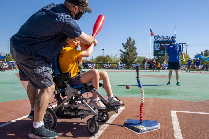 Batter Tristen ÒTÓ Hiner connects with the ball assisted by her father Tim Hiner duri ...