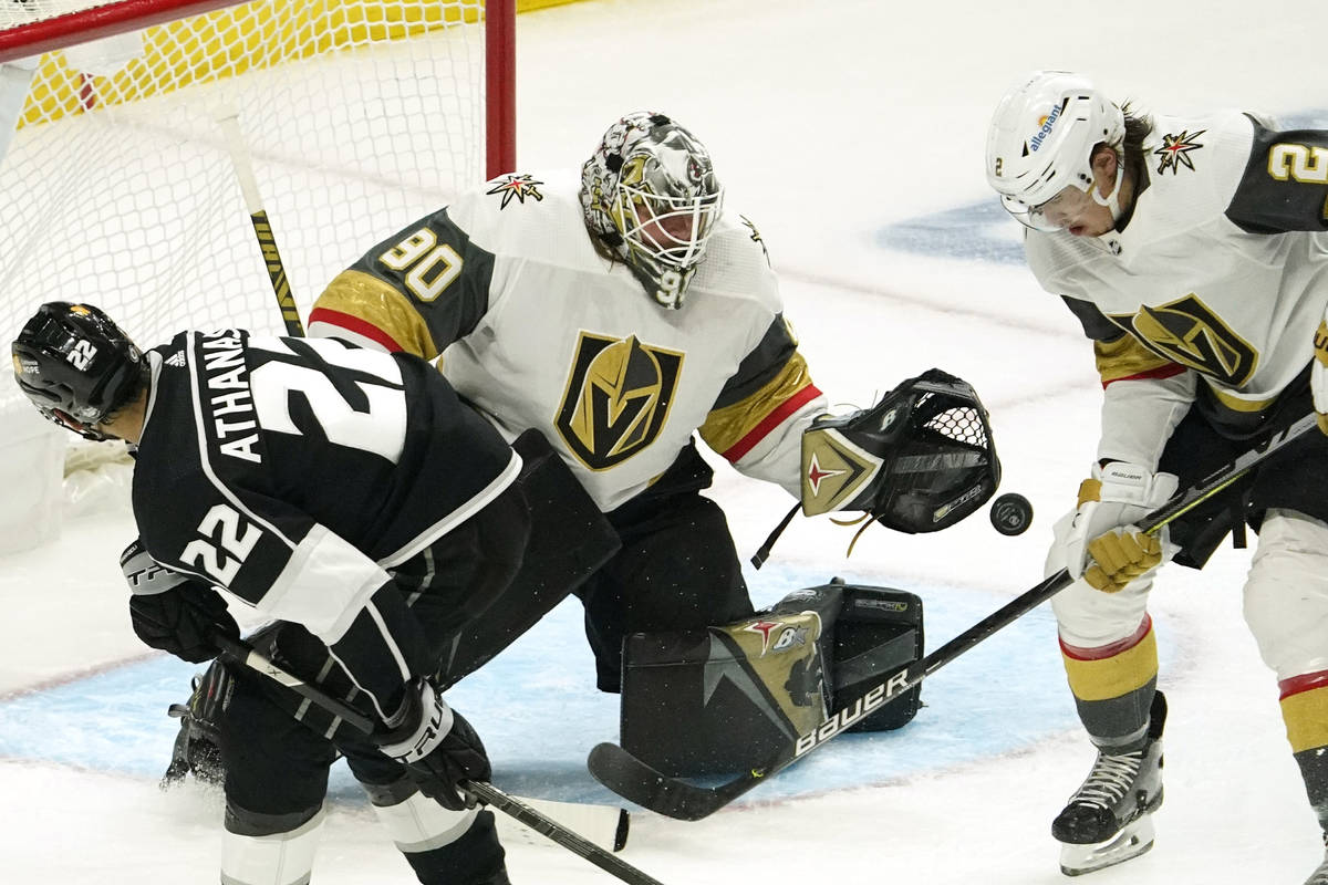 Los Angeles Kings left wing Andreas Athanasiou, left, tries to get a shot past Vegas Golden Kni ...