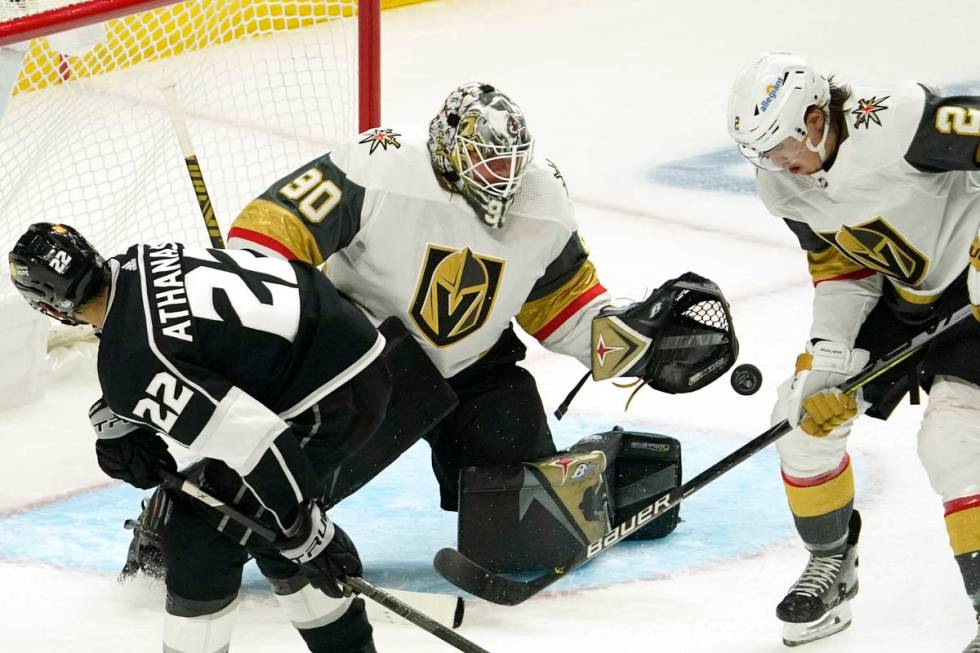 Los Angeles Kings left wing Andreas Athanasiou, left, tries to get a shot past Vegas Golden Kni ...