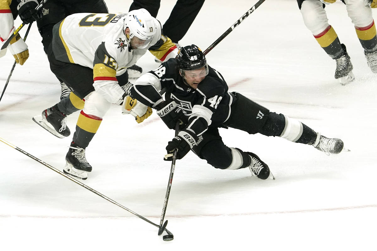 Los Angeles Kings left wing Brendan Lemieux, right, falls while under pressure from Vegas Golde ...