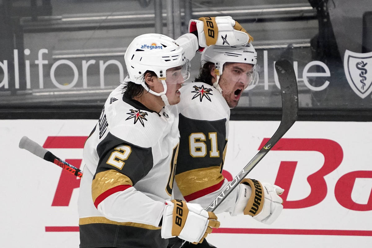 Vegas Golden Knights right wing Mark Stone, right, celebrates his goal with defenseman Zach Whi ...