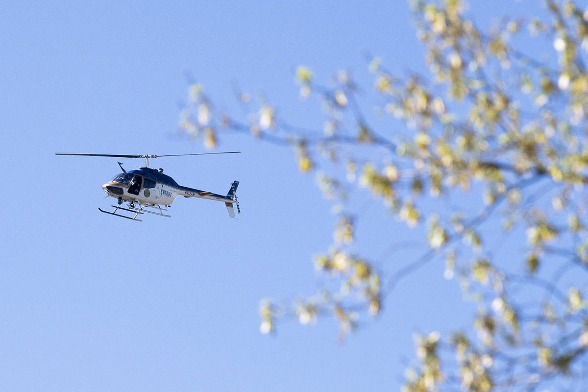 A law enforcement helicopter flies over the area of Austin-East Magnet High School after a repo ...