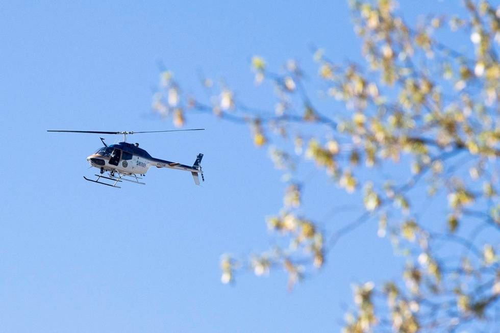 A law enforcement helicopter flies over the area of Austin-East Magnet High School after a repo ...