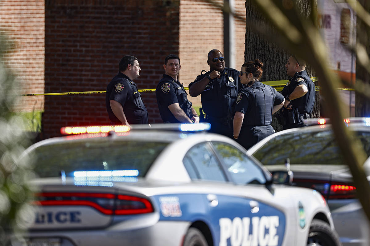 Knoxville police work the scene following a shooting at Austin-East Magnet High School in Knoxv ...
