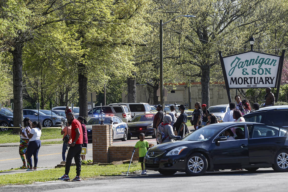 People gather outside Austin-East Magnet High School in Knoxville, Tenn., following a shooting ...
