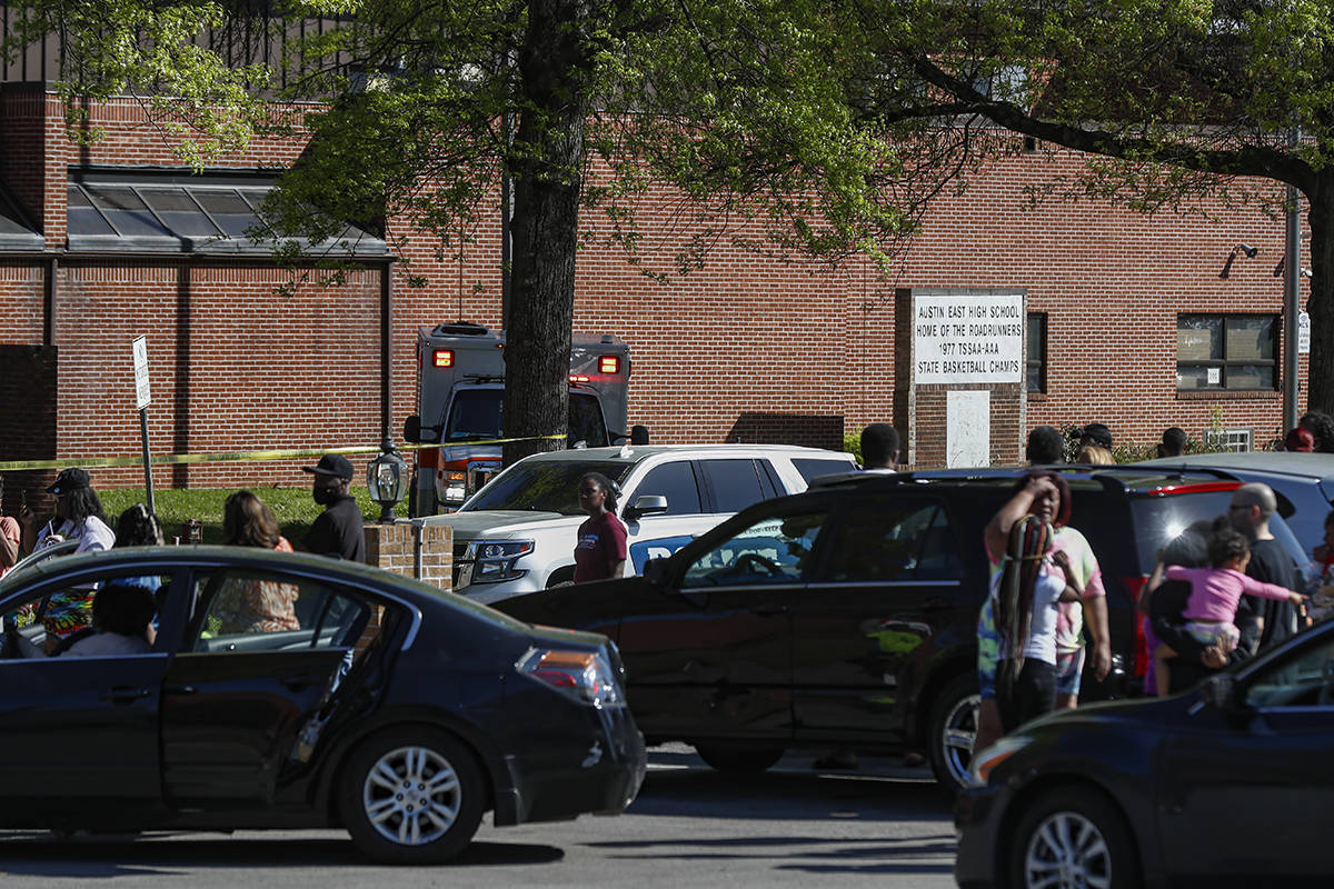 People gather outside Austin East High School in Knoxville, Tenn., as Knoxville police work the ...