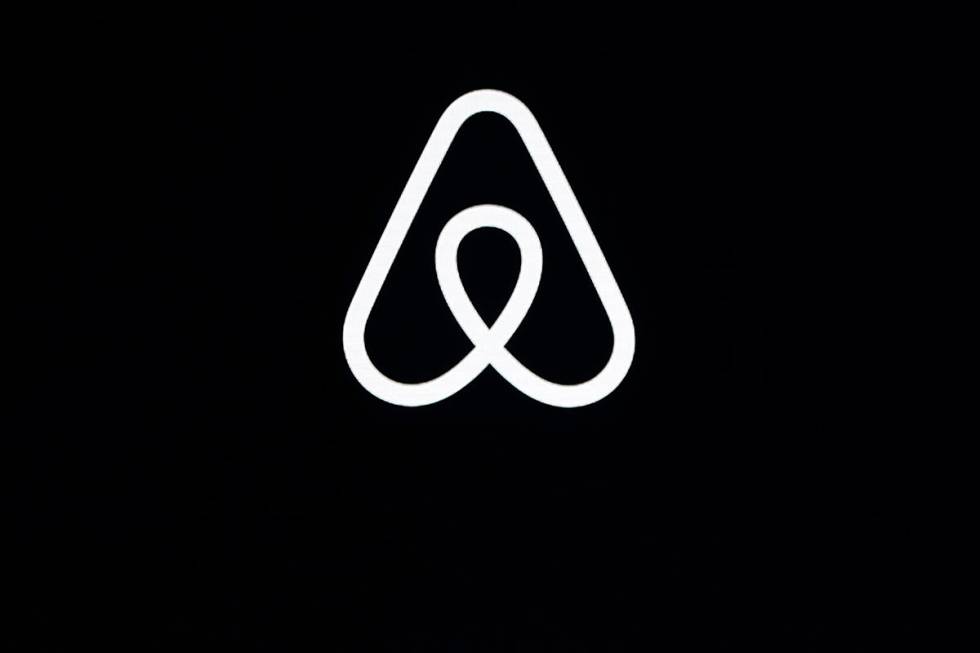 FILE - This Feb. 22, 2018, file photo shows an Airbnb logo during an event in San Francisco. (A ...