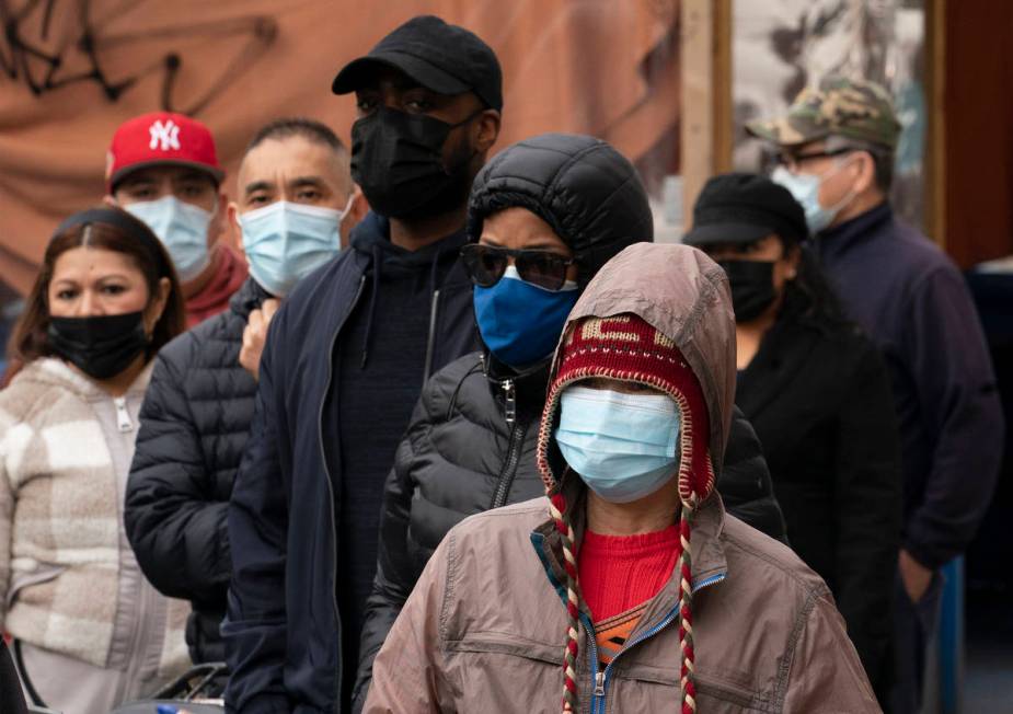 Restaurant workers and restaurant delivery workers wait in line to sign up for Johnson & Jo ...