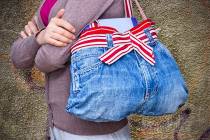 An old pair of woman's jeans converted into a handbag is an example of "upcycling." (Getty Images)