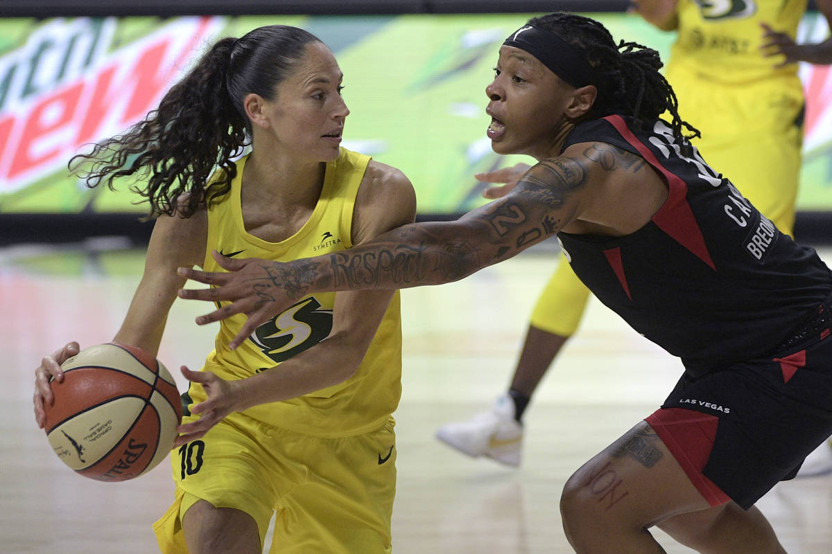 Seattle Storm guard Sue Bird (10) is defended by Las Vegas Aces forward Emma Cannon (32) during ...