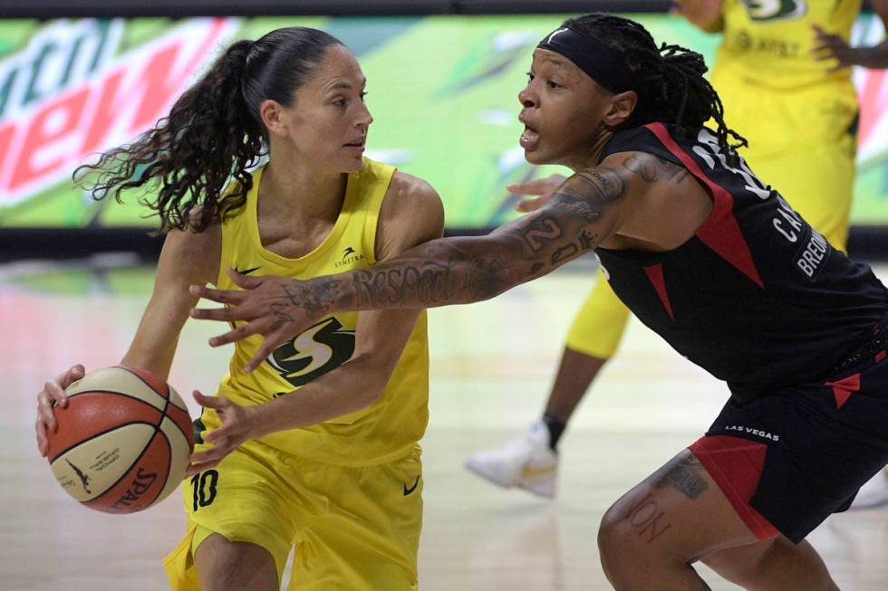 Seattle Storm guard Sue Bird (10) is defended by Las Vegas Aces forward Emma Cannon (32) during ...