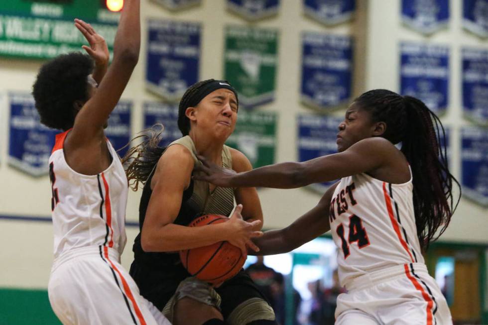 Spring Valley's Garrisen Freeman (32) drives the ball past West Anchorage's Ah'Kayzee Galloway ...