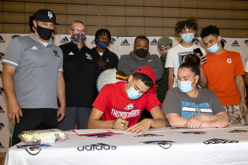 Desert Pines senior Anthony Swift, second from left, sits next to his mother Jay Douwes, during ...