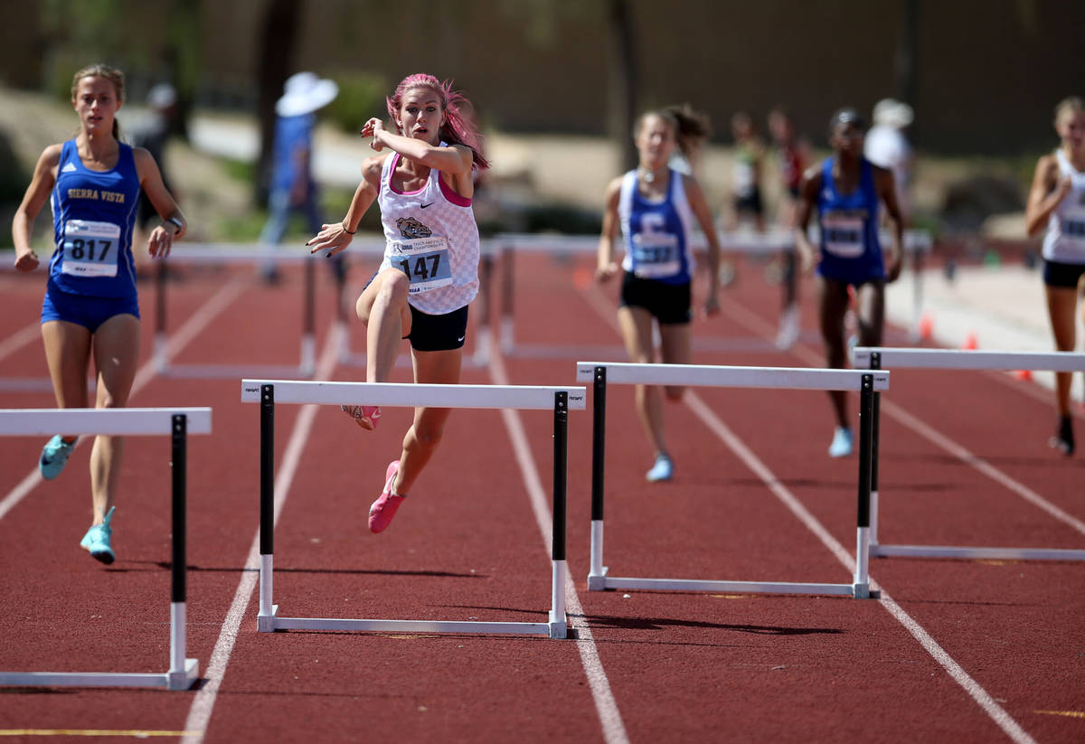 Quincy Bonds Centennial, second from left, on her way to winning Class 4A 300 meter hurdles in ...