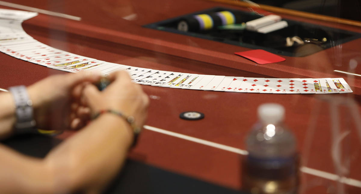 A player watches cards in $175 No-Limit Hold'em Ladies tournament during 2021 Nevada State Ladi ...