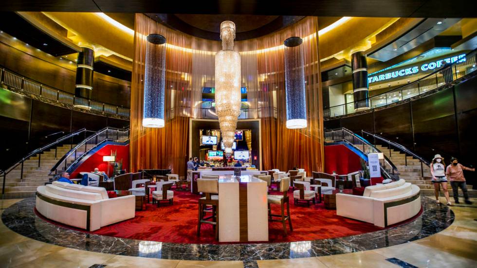 The Lobby Bar is the plush red-carpeted lounge nestled at the foot of two winding staircases, b ...