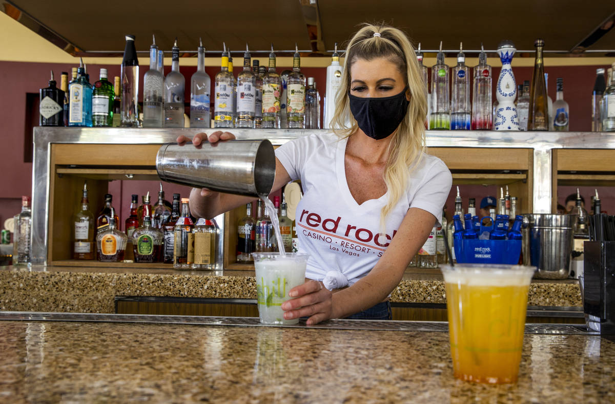 Bartender Tiffany Mann finishes off a cucumber mint cooler beside a spiked pog drink at the San ...