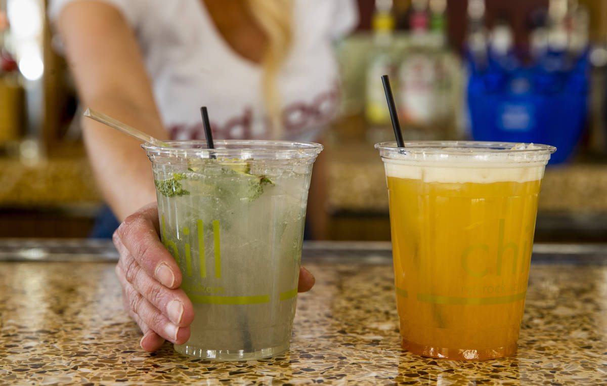 Bartender Tiffany Mann offers a cucumber mint cooler, left, beside a spiked pog drink at the Sa ...
