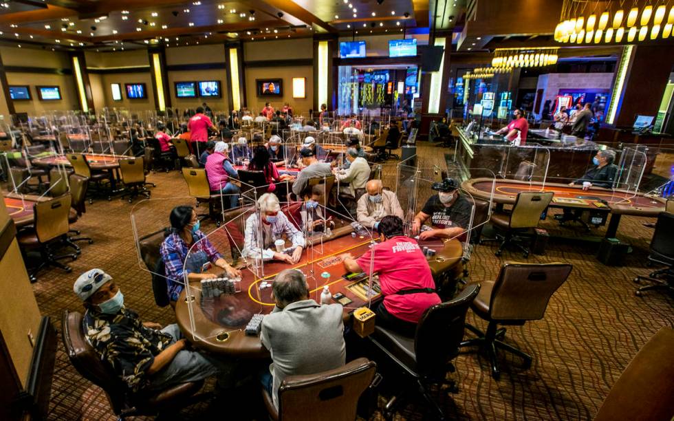 Players are separated by plexiglass during play in the poker room.( L.E. Baskow/Las Vegas Revie ...
