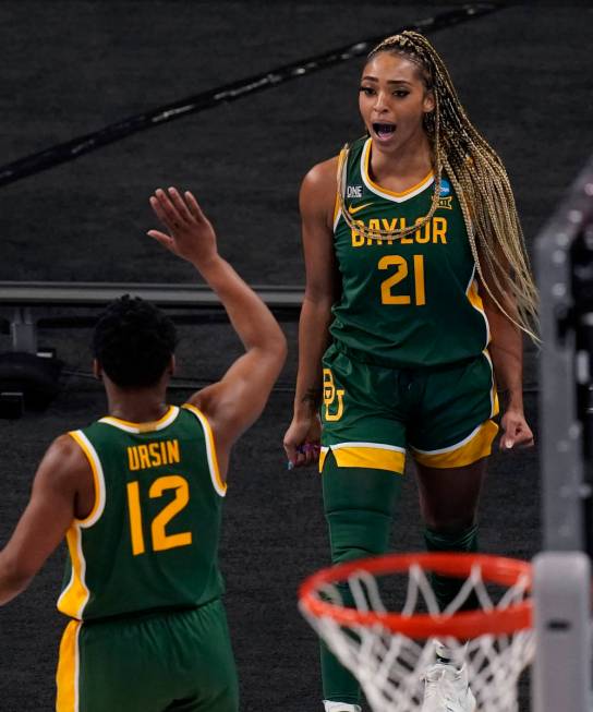 Baylor guard DiJonai Carrington (21) celebrates a score against UConn with teammate Moon Ursin ...