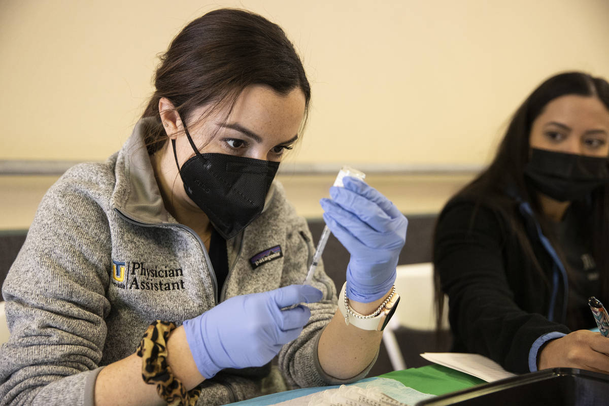 Touro University Nevada physician assistant student Madison Ginis extracts COVID-19 vaccines fr ...