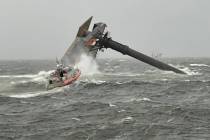 A Coast Guard Station Grand Isle 45-foot Respone Boat-Medium boatcrew heads toward a capsized 1 ...