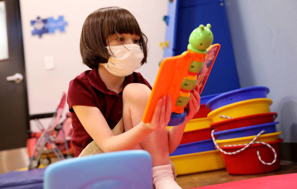 Akara Haase, 6, takes a break in a learning and play area called The Park at the Center for Aut ...