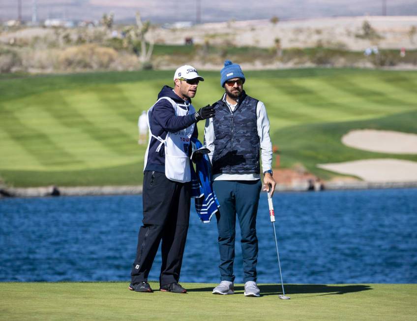 Chandler Blanchet of Jacksonville Beach, Fla., right, consults his golf caddy on fourth hole du ...