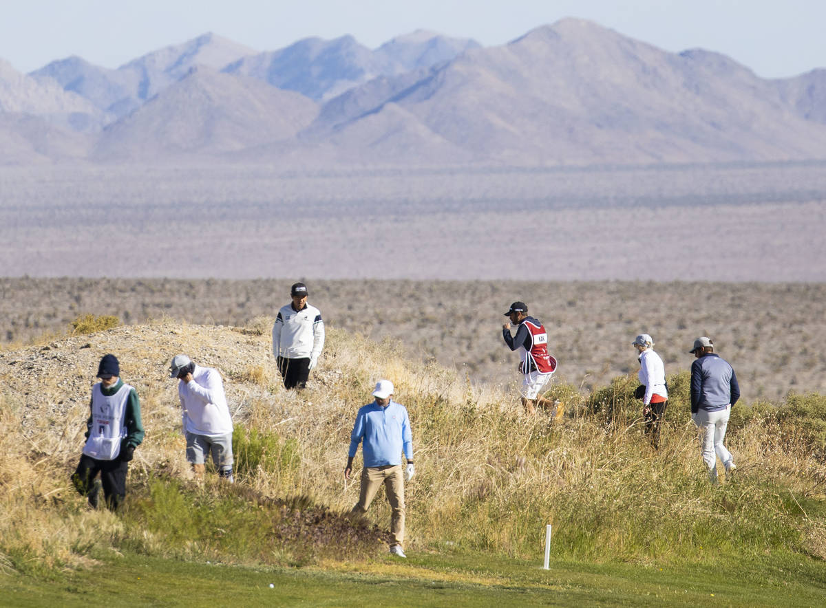 Triple-A golfers and their caddies search for a lost golfball during the first round of the MGM ...
