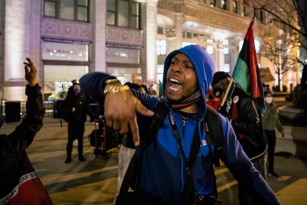 Lamon Reccord leads a chant as dozens of protesters march down the Magnificent Mile after the c ...