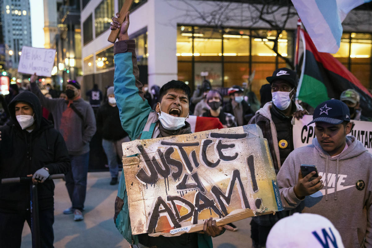 Dozens of protesters march down the Magnificent Mile after the city of Chicago released videos ...