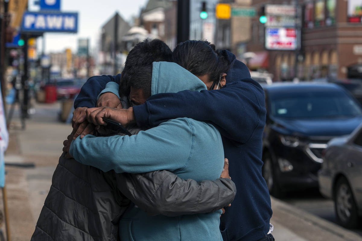 Baltazar Enriquez, Kristian Armendariz, and Enrique Enriquez embrace one another, after the bod ...