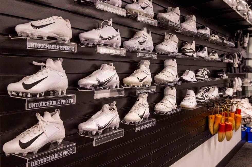 A rack of possible athletic shoe choices for players hangs in the equipment room within the Las ...
