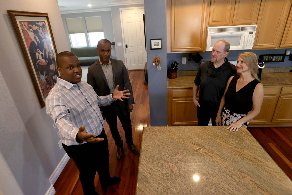 Realtor Shawn Cunningham, left, and his brother Kyle Cunningham, show a Las Vegas house for sal ...