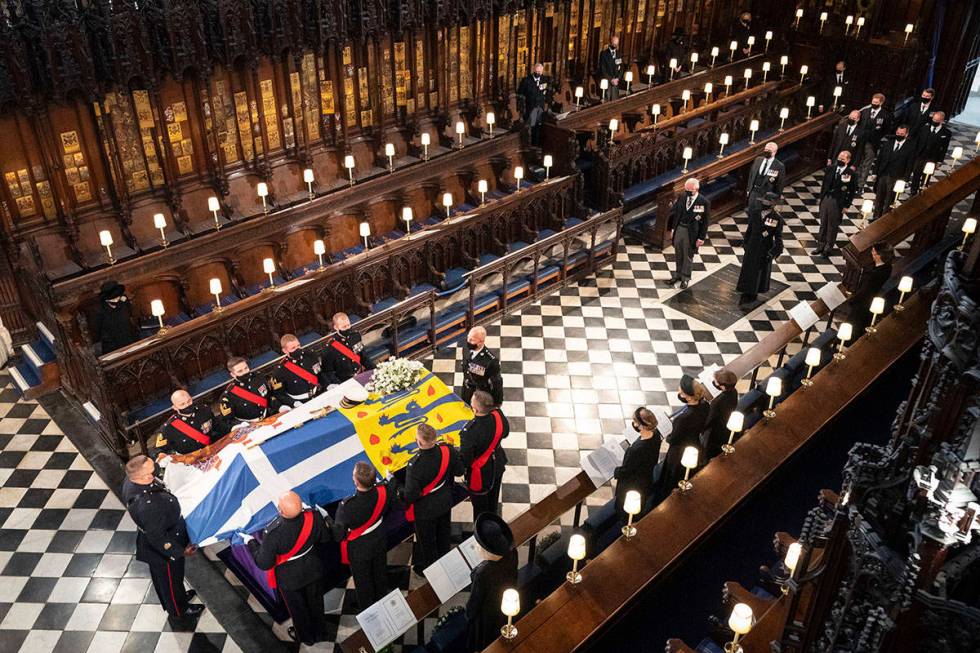 Queen Elizabeth watches as pallbearers carry the coffin of the Duke of Edinburgh during his fun ...