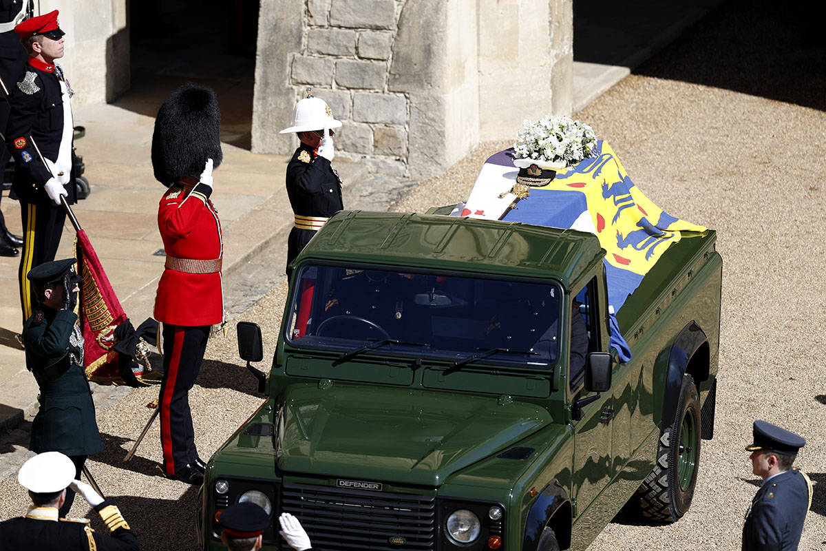 Members of the military salute the coffin of Britain's Prince Philip as it sits atop a modified ...