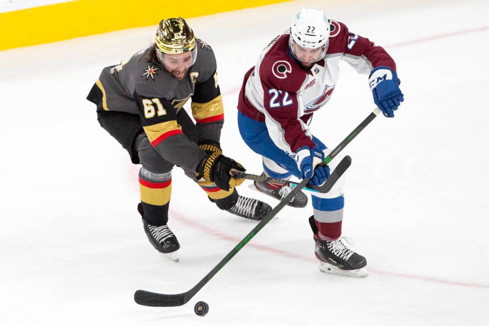 Golden Knights right wing Mark Stone (61) and Colorado Avalanche defenseman Conor Timmins (22) ...