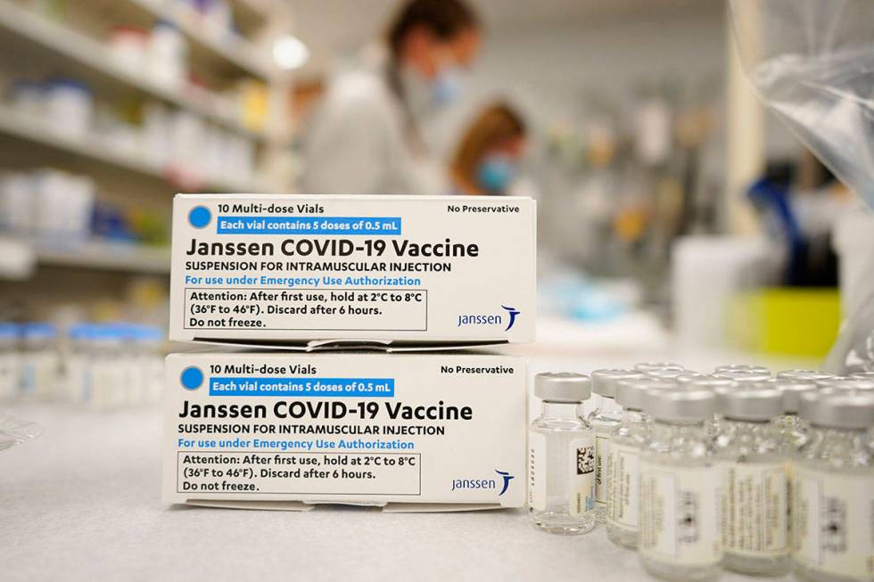 FILE - In this March 6, 2021, file photo, boxes stand next vials of Johnson & Johnson COVID-19 ...