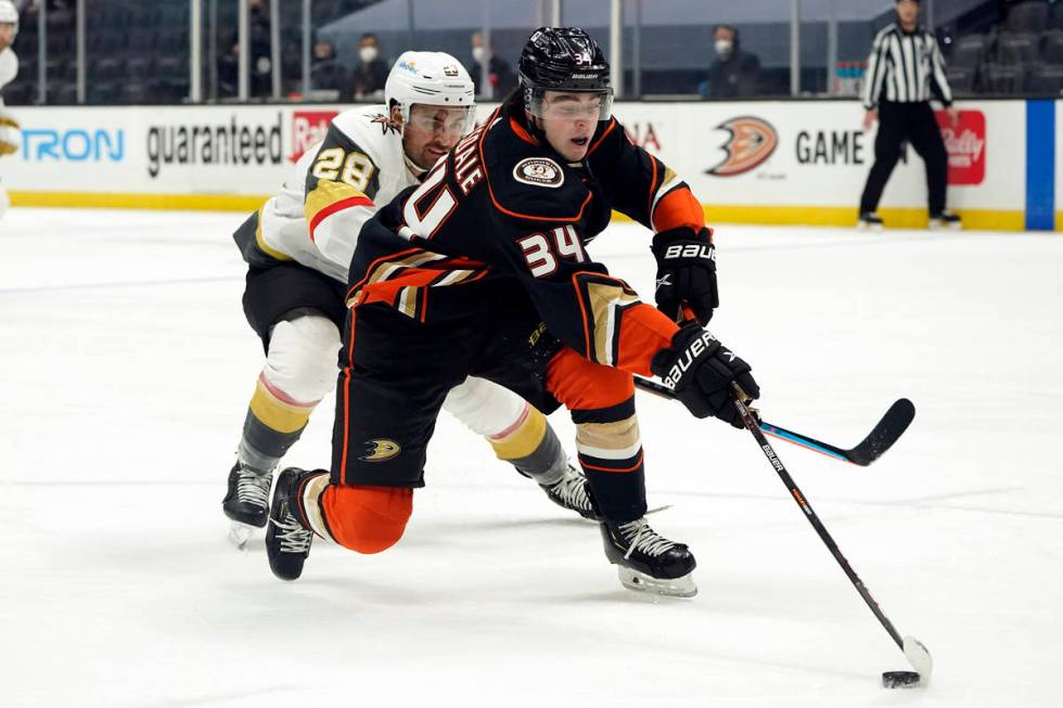 Anaheim Ducks defenseman Jamie Drysdale (34) reaches for the puck in front of Vegas Golden Knig ...