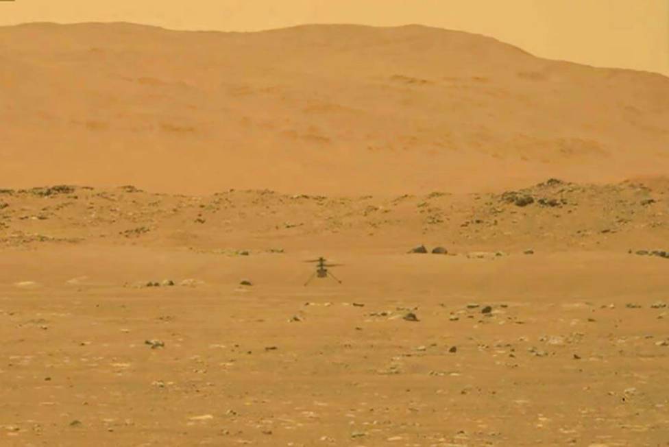 In this image from NASA, NASA's experimental Mars helicopter Ingenuity lands on the surface of ...