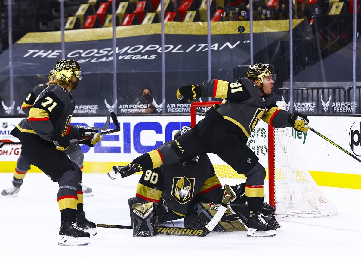 The puck flies over the head of Golden Knights' Jonathan Marchessault (81) as he tries to avoid ...