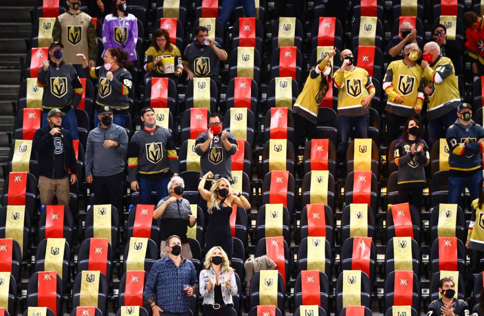 Golden Knights fans celebrate a goal by Mark Stone, not pictured, during the third period of an ...