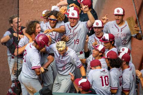 Desert Oasis teammates celebrate a run by Jacob Walsh (21) over Reno in the second inning durin ...