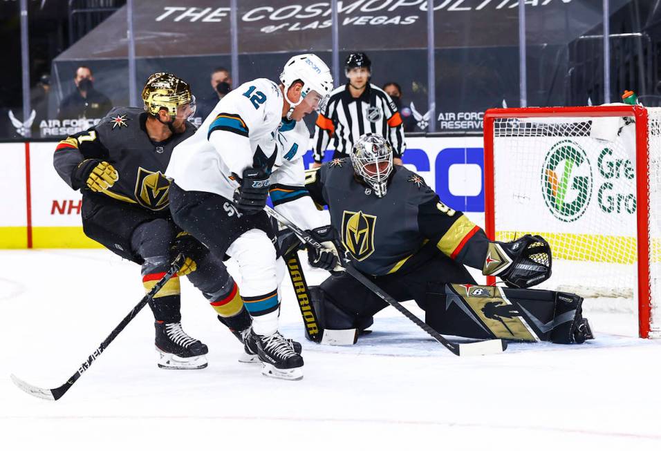 Golden Knights goaltender Robin Lehner (90) reaches out to block a shot from San Jose Sharks' P ...