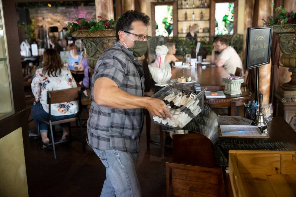 Joe Pierro, owner of Market Grille Cafe, works the host desk at his restaurant. Before the pand ...