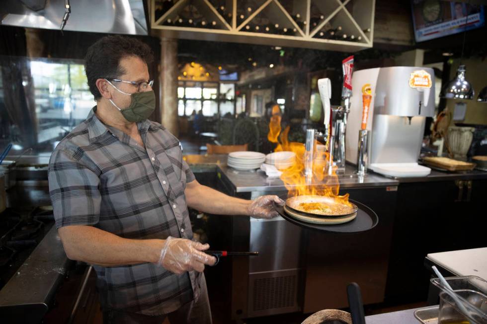 Joe Pierro, owner of Market Grille Cafe, prepares Saganaki at his restaurant. (Erik Verduzco/La ...