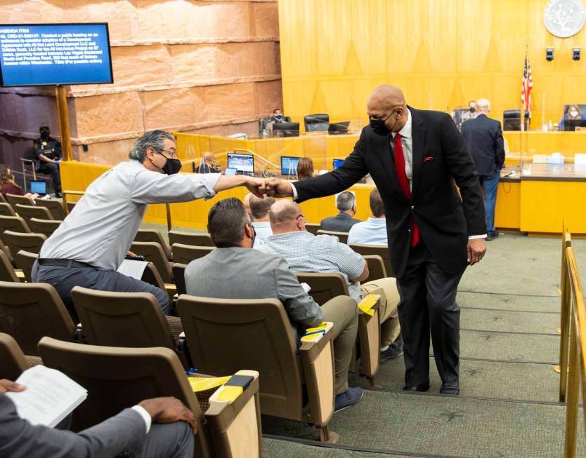 Former NBA player Jackie Robinson exchanges fist bumps with supporters inside commission chambe ...