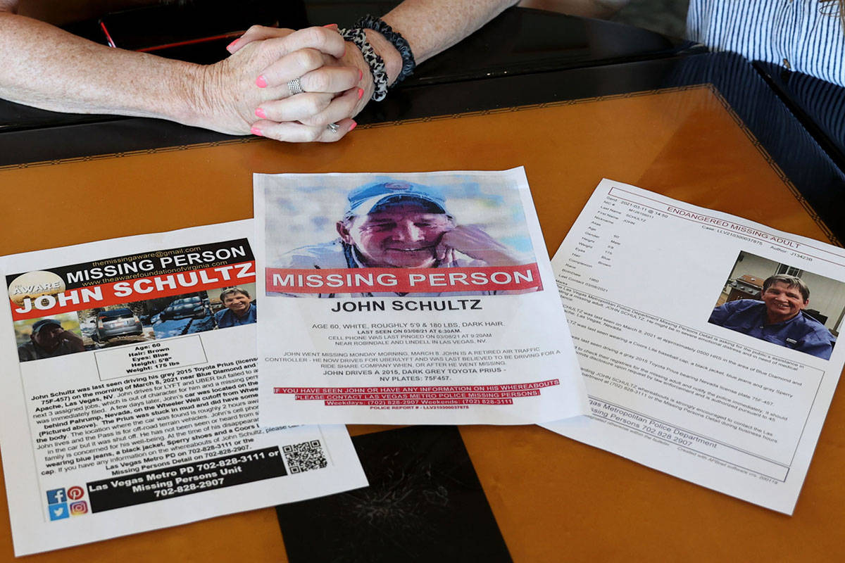 Missing person John Schultz's flyers are seen as Schultz's wife, Barbara, left, and daughter Ni ...