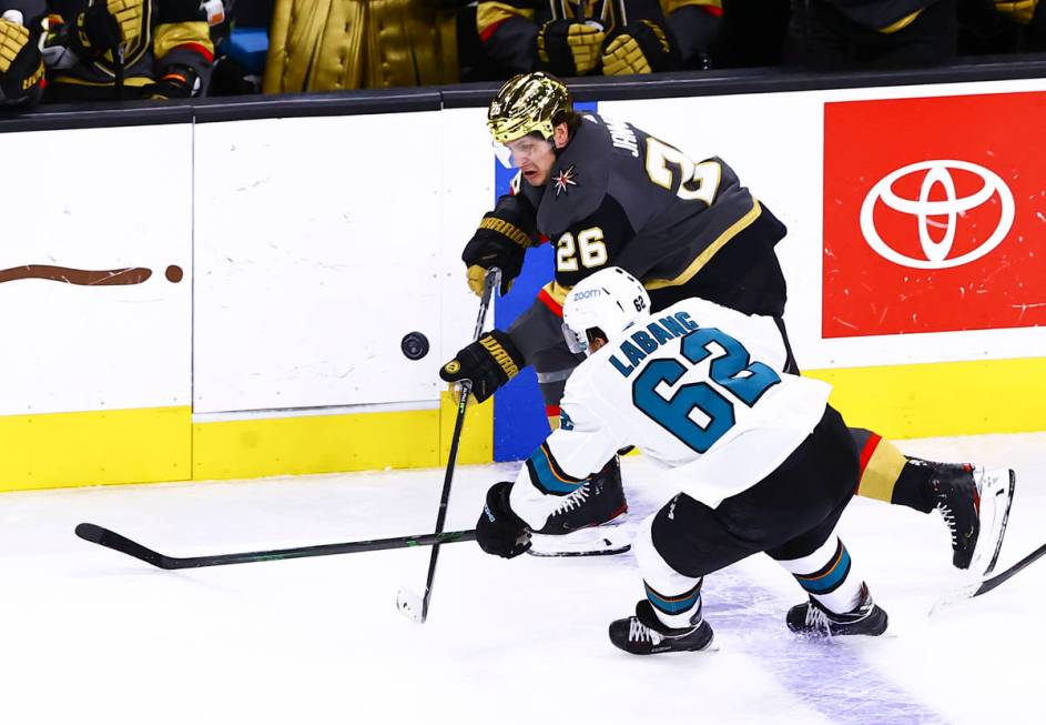 Golden Knights' Mattias Janmark (26) and San Jose Sharks' Kevin Labanc (62) fight for puck duri ...